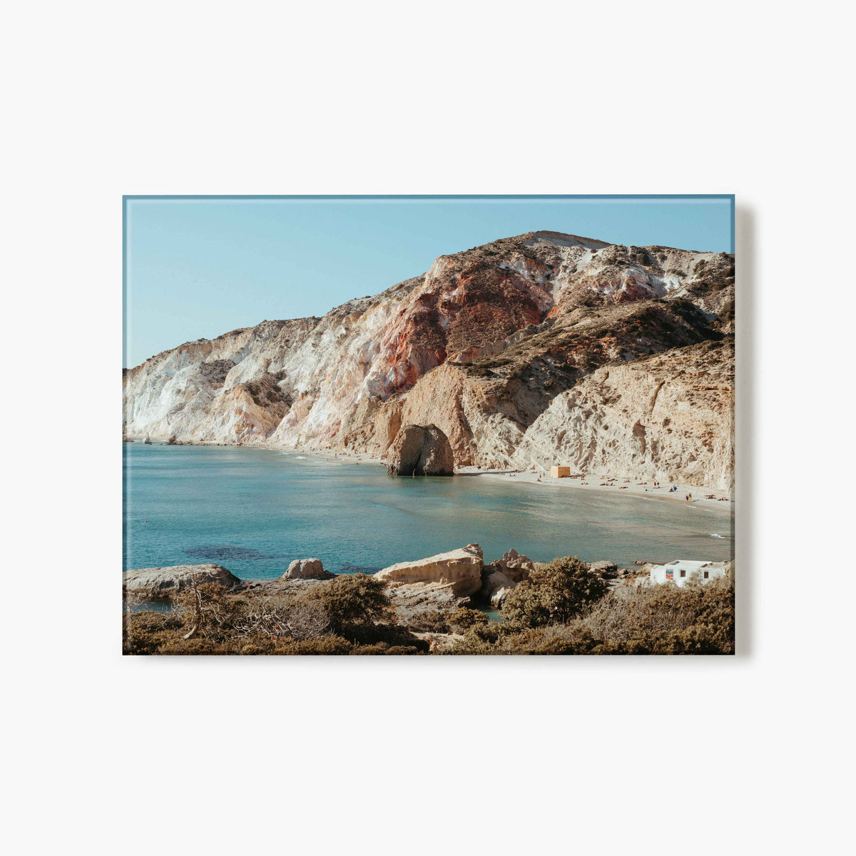 Glass print of a landscape with rocky cliffs and a body of water on a white background
