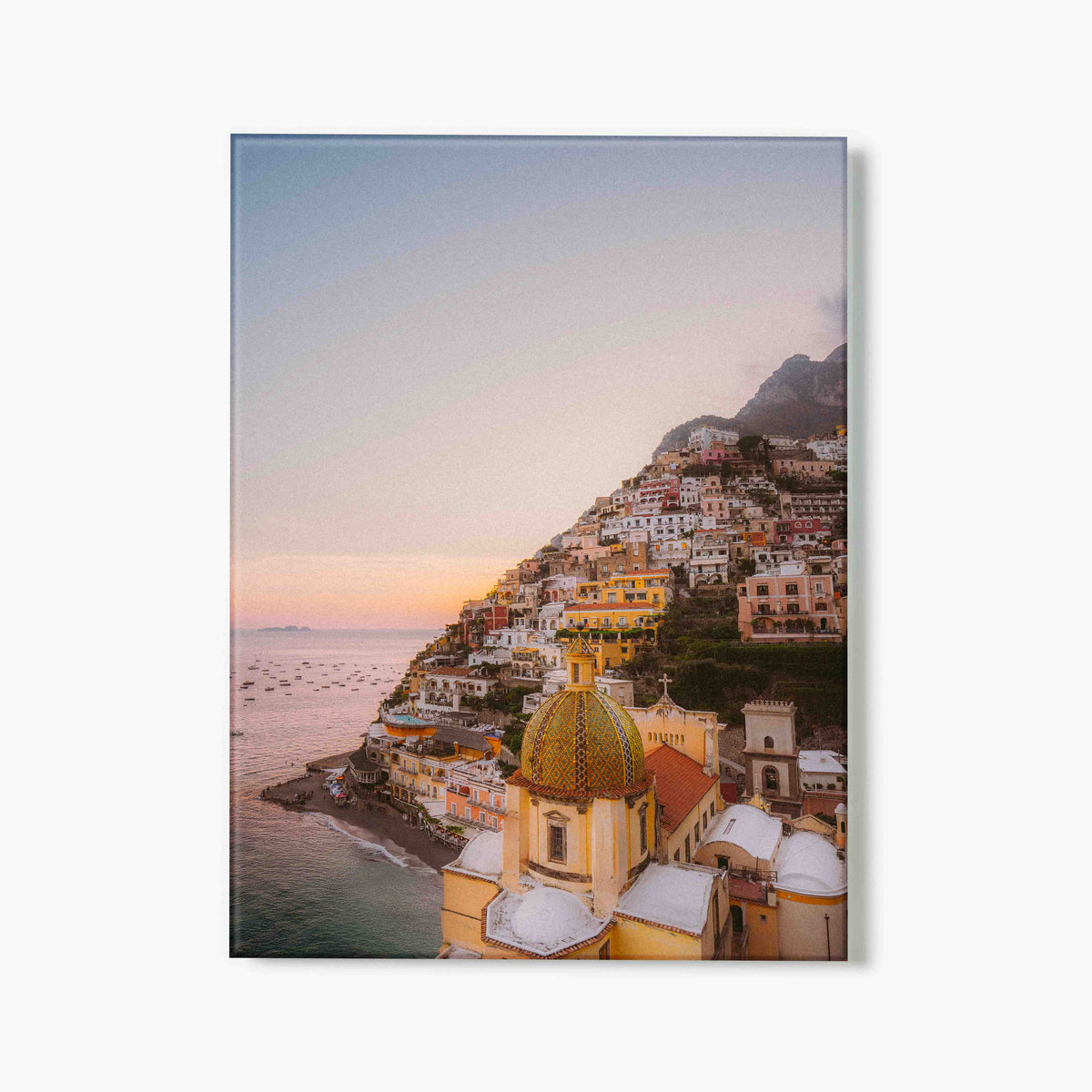 Glass print of Positano hillside by the sea with colorful buildings and a mountain in the background