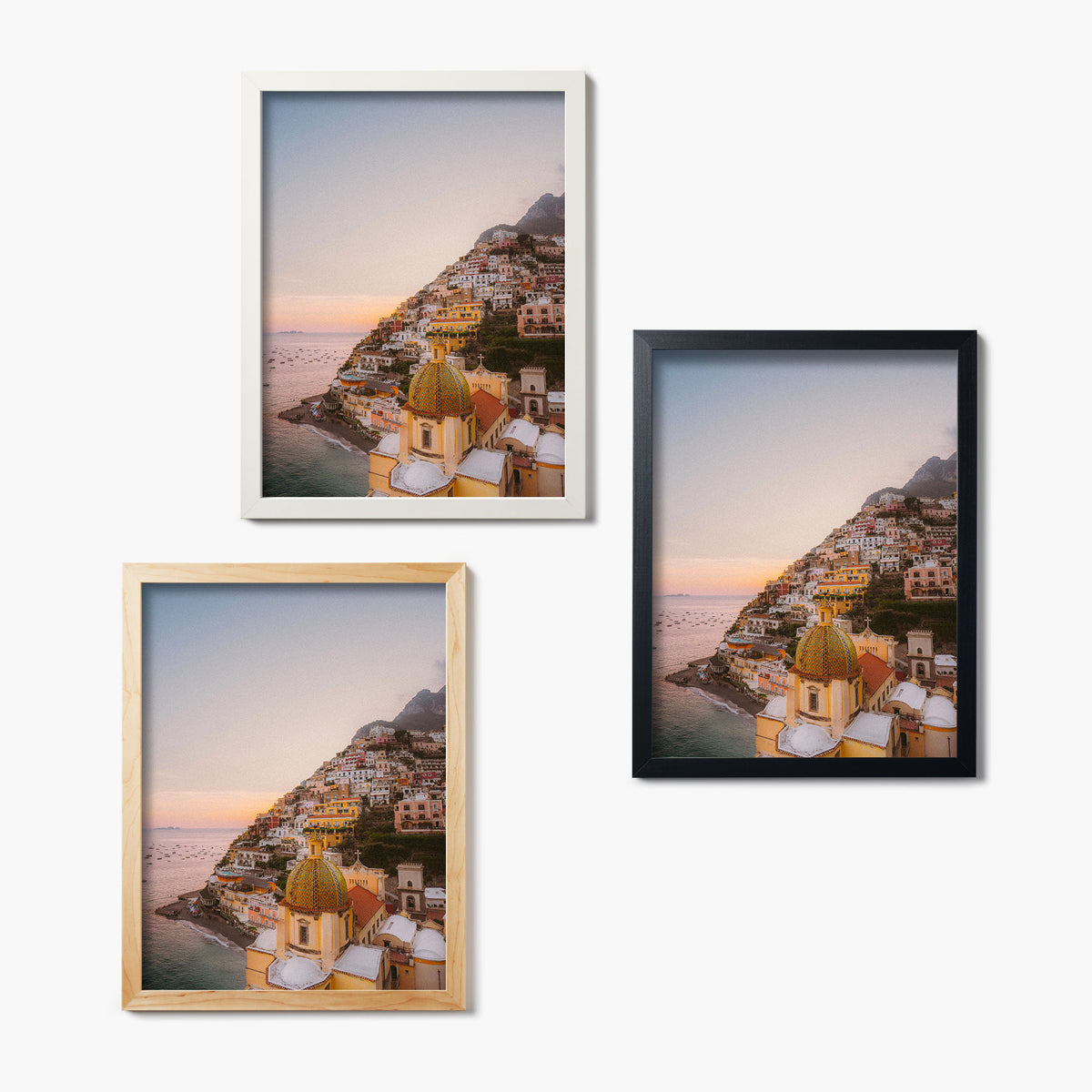 Three framed glass prints of colorful coastal Positano hills on a white background