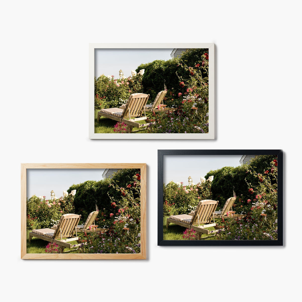 Three framed glass prints of a garden scene with chairs and flowers on a white background.