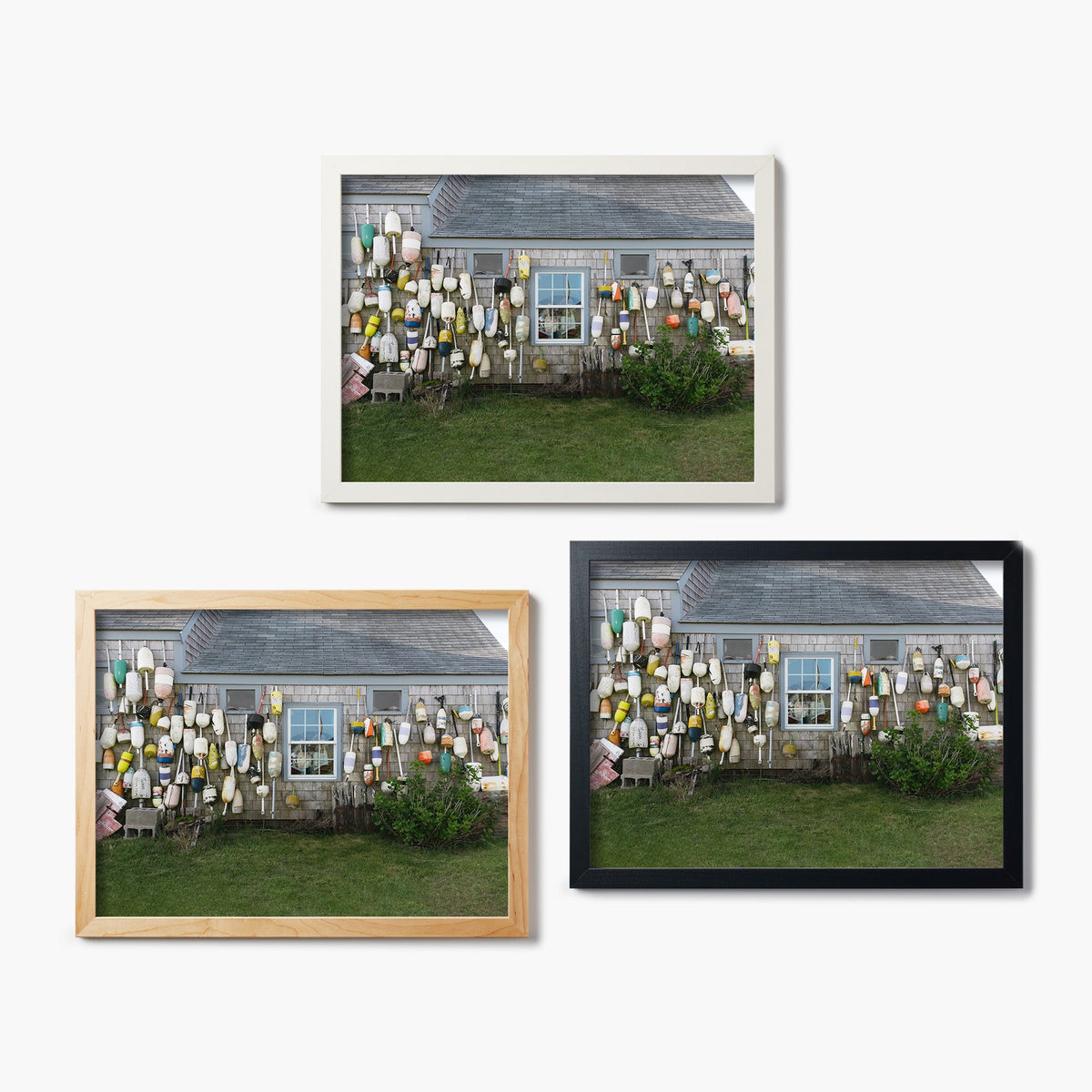 Three framed glass prints of a house with various buoys on the wall, displayed against a white background.