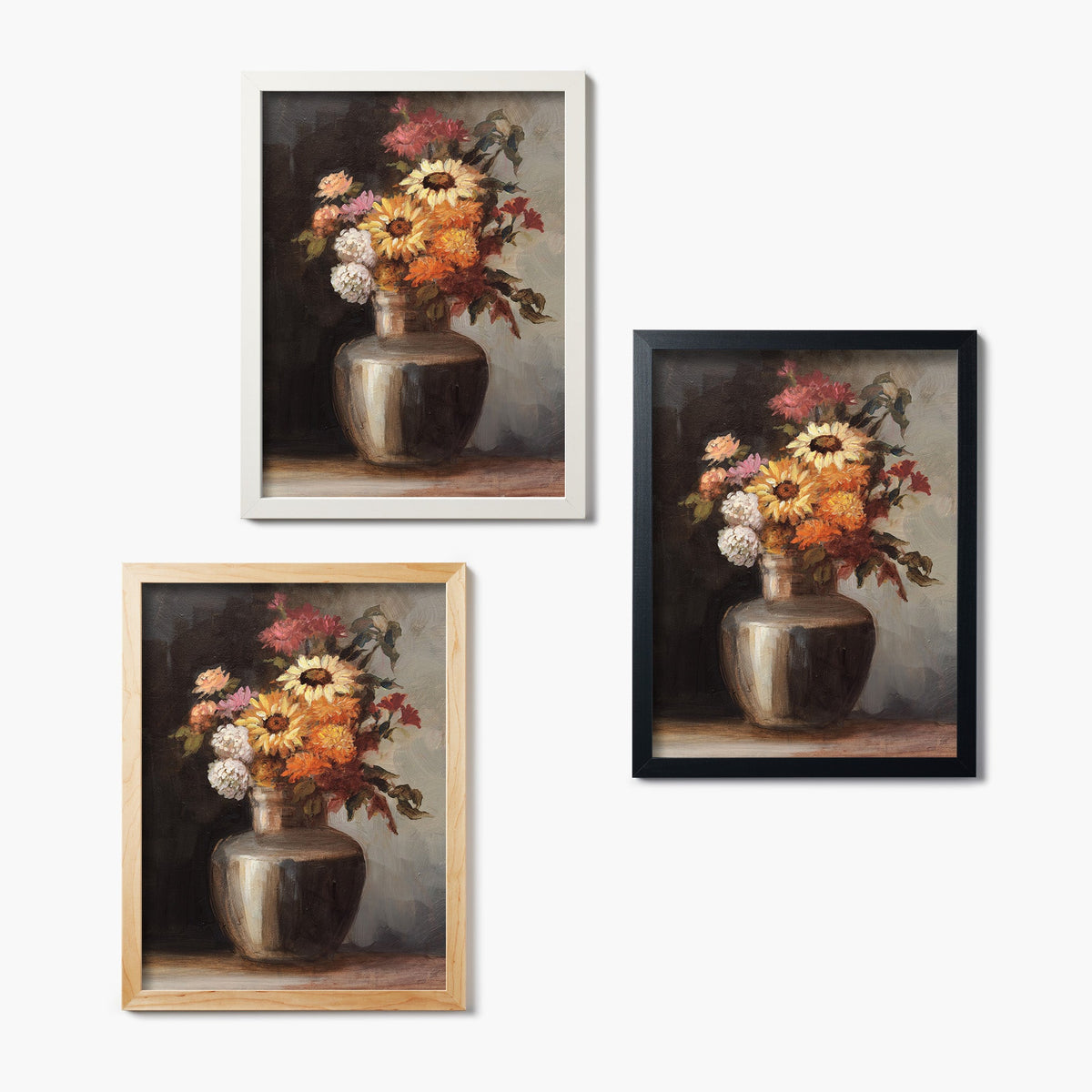 Set of three framed glass prints of a painting of a vase with autumnal colored flowers
