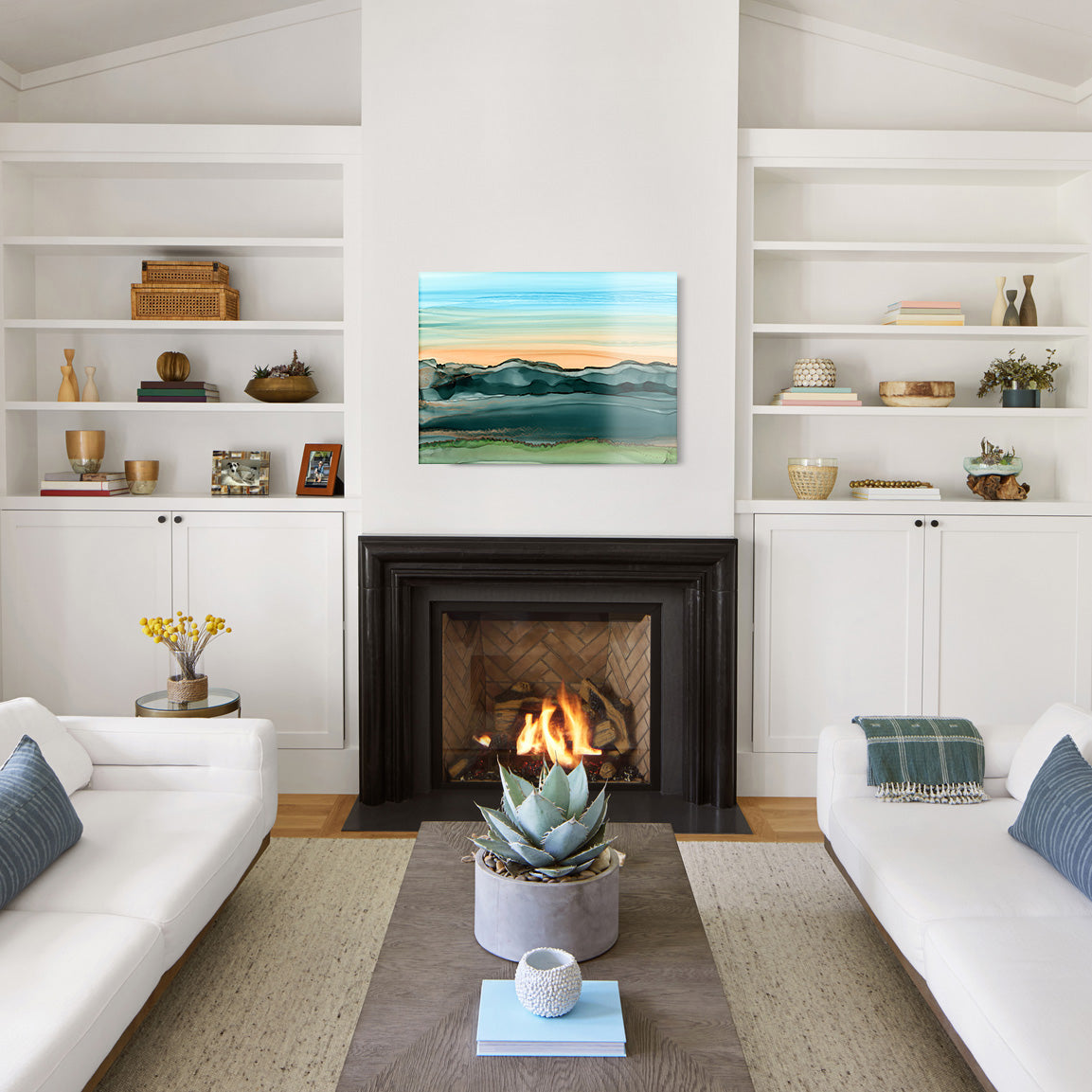 Living room with white walls, a fireplace, and a glass print of an abstract landscape above the mantel.