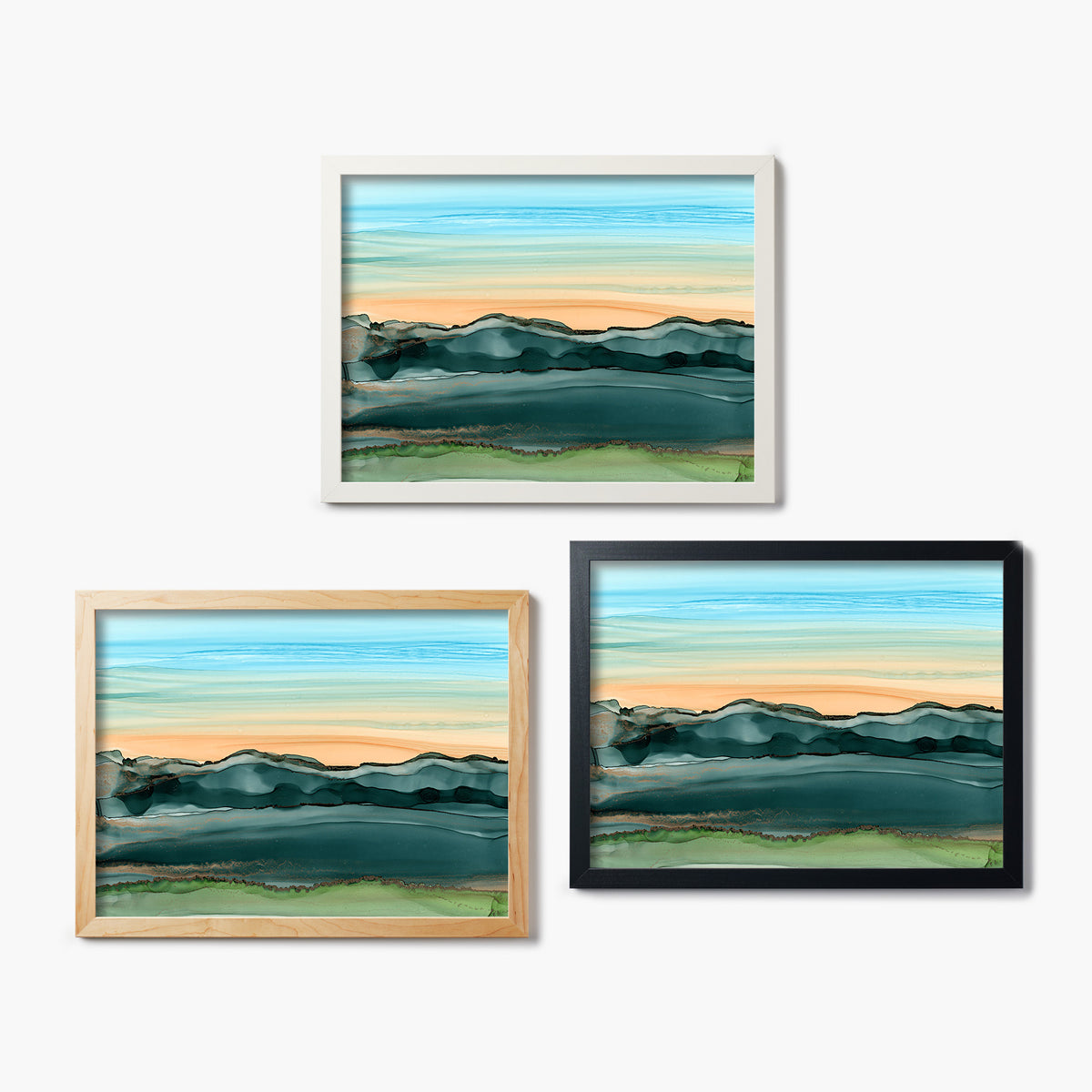 Three framed glass prints of abstract landscapes on a white background