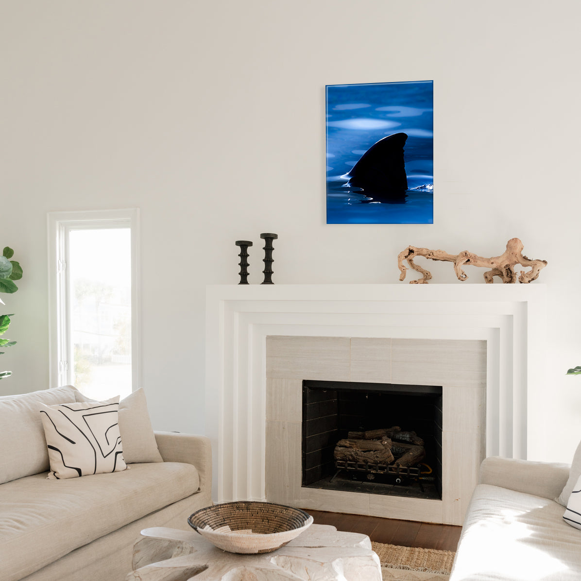 Shark fin art glass print on a wall above a fireplace in a living room.