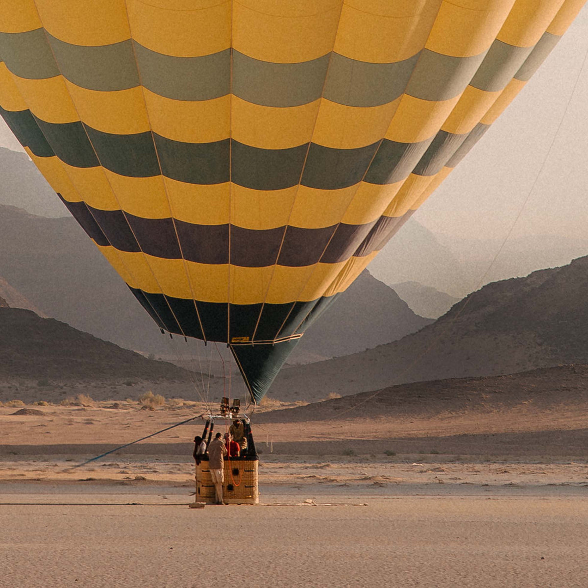 Close up of photo on hot air balloon with striped pattern in a desert landscape