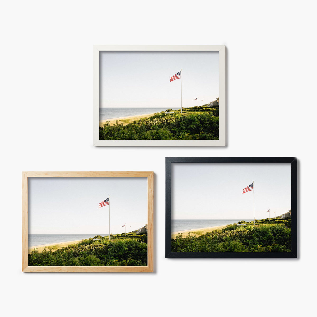 Three framed glass prints of a scenic landscape with a flag on a white background