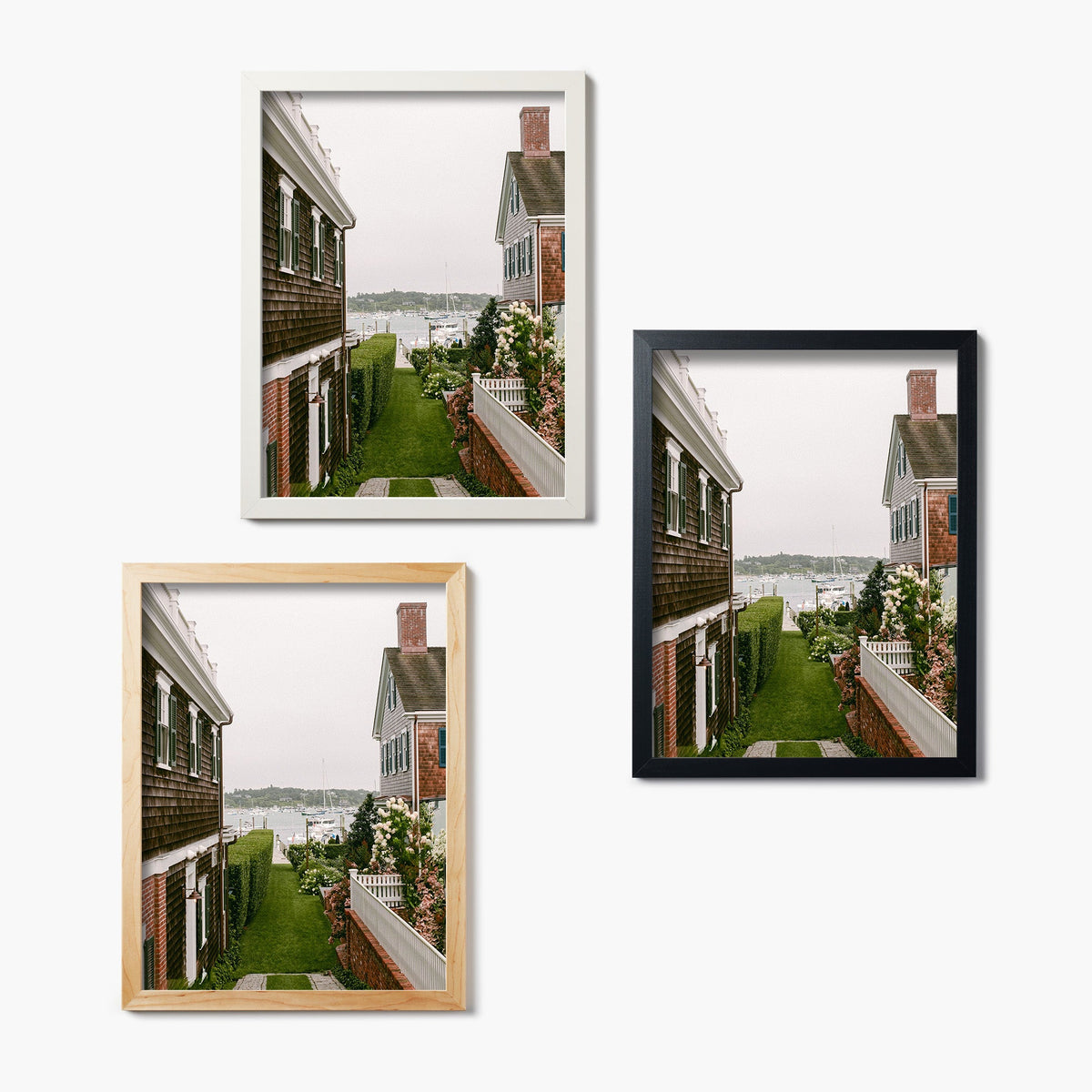 Three framed glass prints of a house with a garden on a white background